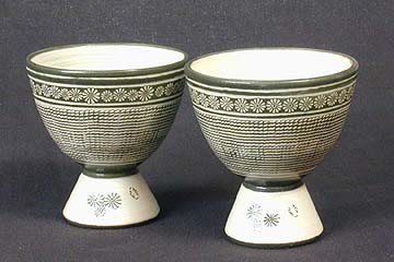 Modern celadon cups with stamped chrysanthemum pattern around the top of the cup body, and a rope curtain pattern over the remainder of the body. Korean-Arts' item BCCS011