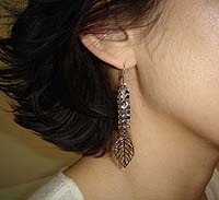 White Metal Leaf Earrings - modelled